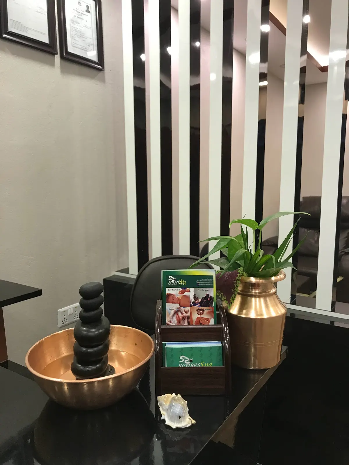 Copper bowl with stacked basalt massage stones at the reception
