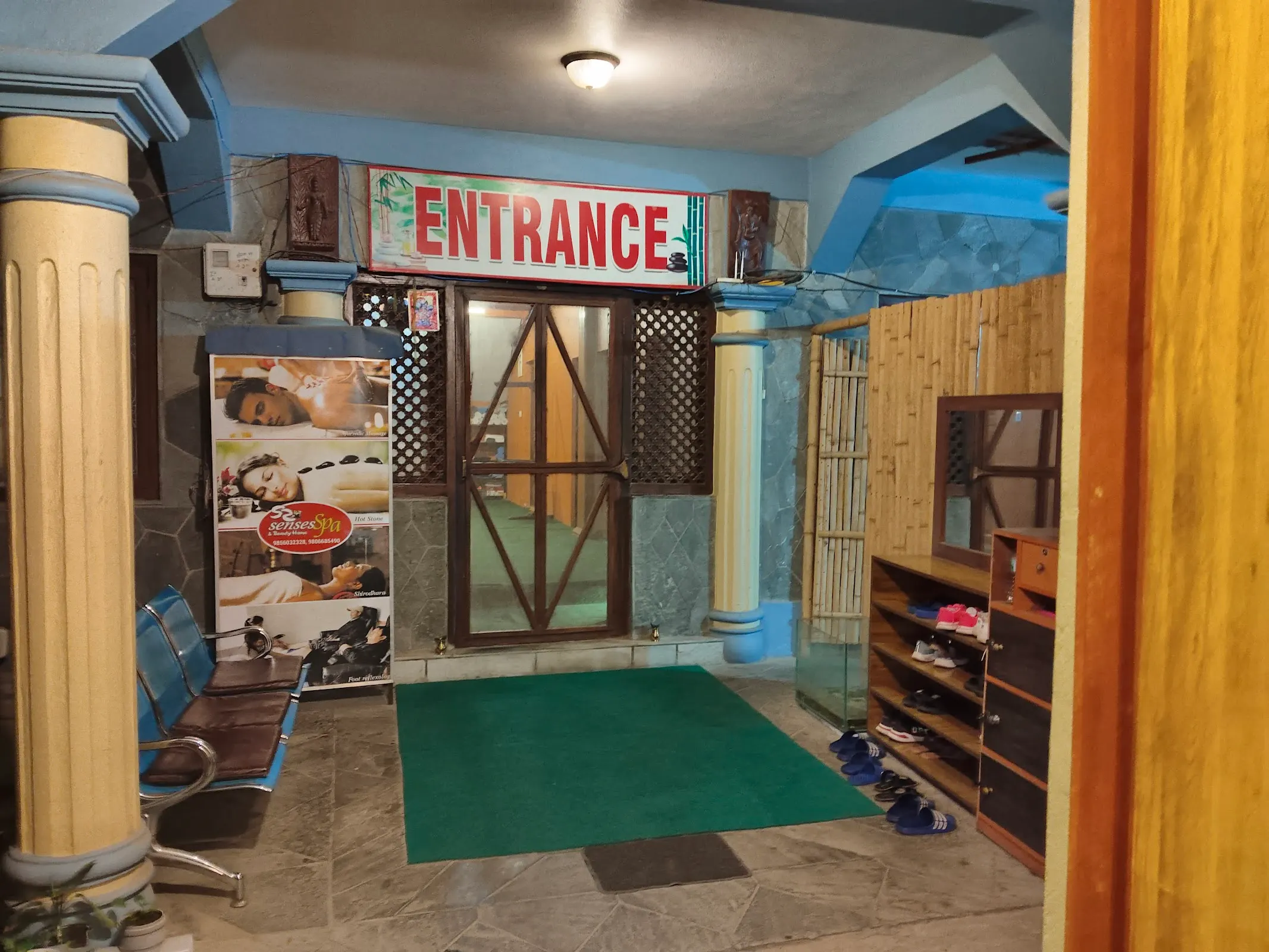 Spa entrance with shoe rack and welcome mat