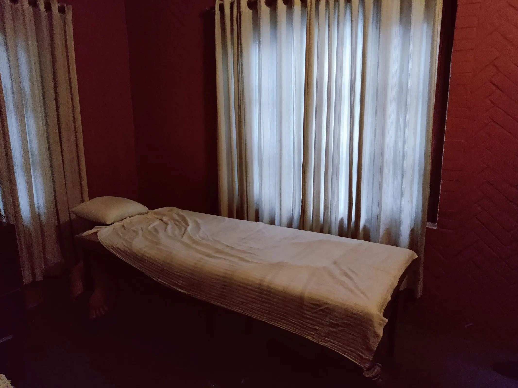 Single treatment room in deep ember tones